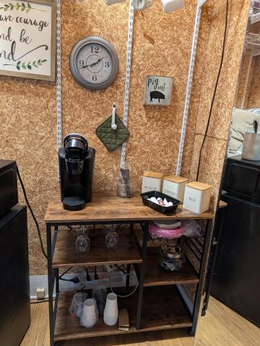 a table in a kitchen with a clock on a wall at Cozy, Cute, Private Ozark Suite 5 Mins to Hospital in Ozark