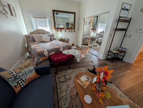 a living room with a couch and a table at Cozy, Cute, Private Ozark Suite 5 Mins to Hospital in Ozark