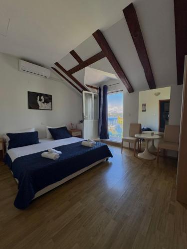 a bedroom with a large bed and a large window at Apartment Boras Lux in Cavtat