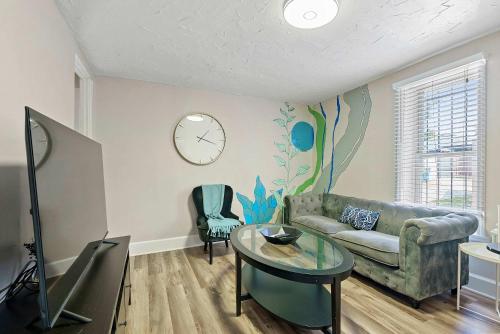 a living room with a couch and a table at CGV - Unique and Memorable 3BDR Stay in Columbus