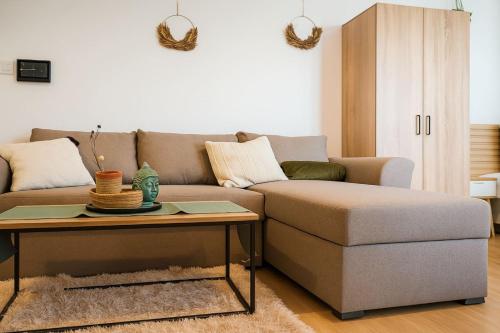 a living room with a couch and a coffee table at Studio Apartment City Dream in Stara Zagora