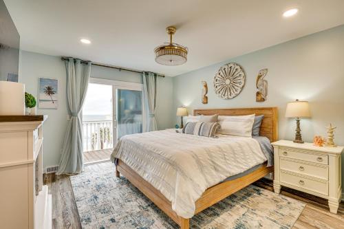 a bedroom with a bed and a window at Poolside Fun + Oceanfront Bliss: Kure Beach Haven! in Kure Beach