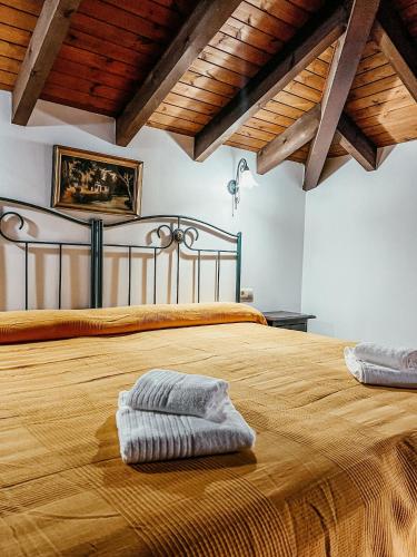 a large bed with two towels on top of it at Apartamentos y Pensión El Campanu in Cangas de Onís