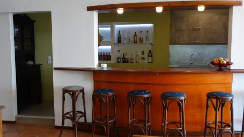 a bar in a kitchen with stools at Dolichi View in Pythagoreio