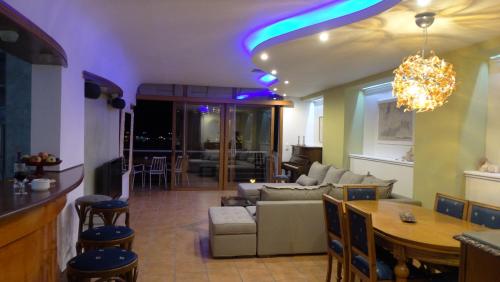 a living room with a couch and a table at Dolichi View in Pythagoreio