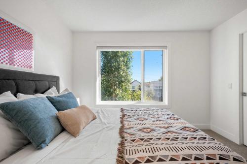 a bedroom with a bed and a window at Inner-City Chic Urban Farmhouse 3 Bds and Ba in Calgary