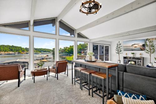 a large living room with a table and chairs at Lake Home Oasis - Sleeps 18 in Lake Ozark