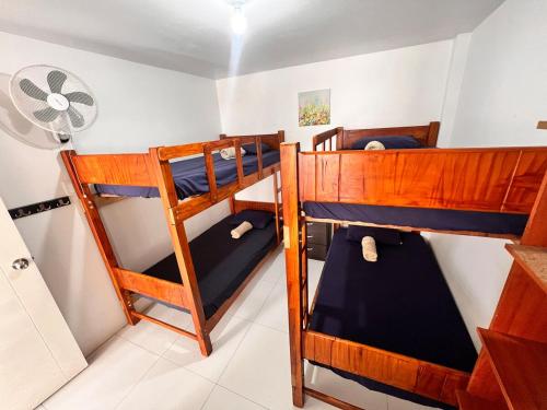 two bunk beds in a room with a fan at Casa Rosé Vacacional in Santa Rosa