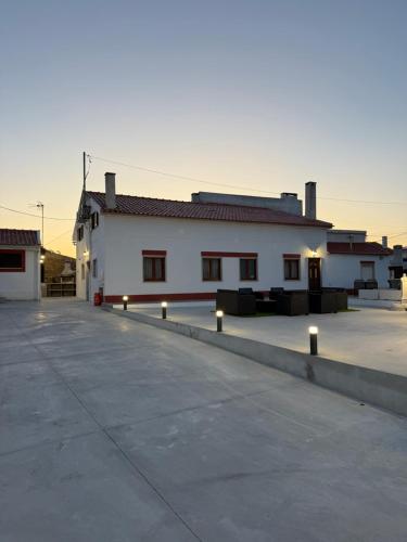 a large white building with lights in a parking lot at Blend-Inn Summer House in São Martinho do Porto