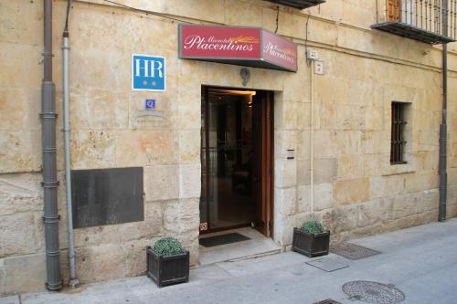a building with a sign on the side of it at Microtel Placentinos in Salamanca