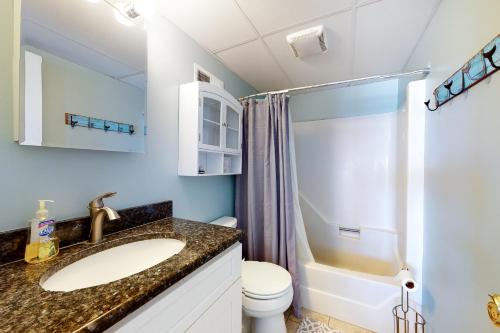a bathroom with a sink and a toilet and a shower at Pelican Beach 304 in Ocean City