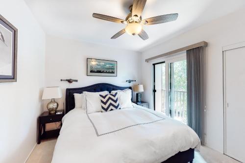 a bedroom with a bed with a ceiling fan at Valley Gem Upper in Elkhorn Village