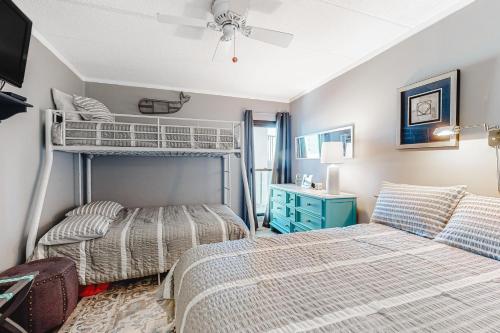 a bedroom with two beds and a bunk bed at Sails II 502 in Ocean City