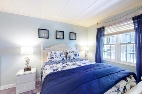 a blue bedroom with a bed and a window at White Marlin 307B in Ocean City