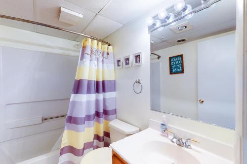 a bathroom with a sink and a shower curtain at White Marlin 307B in Ocean City