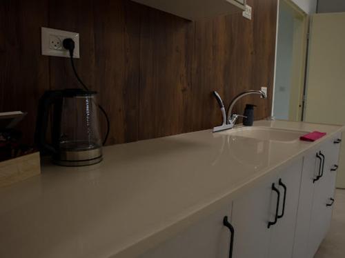 a kitchen counter with a sink and a blender at Vista royal golan in Ein Kinya