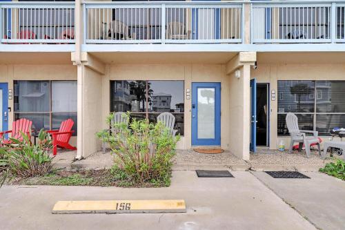 a building with red chairs and a blue door at Relax Inn-Seamist 156 in Port Aransas