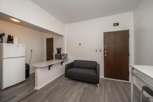 a room with a chair and a desk and a refrigerator at Northside Suite 2 - Cozy Escape in Cincinnati