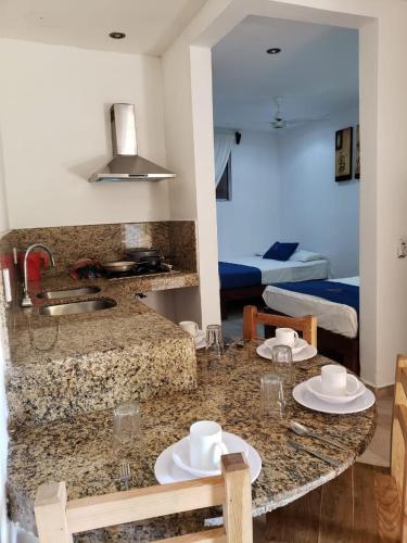 a kitchen with a table with two plates on it at Hotel y Bungalows Resort in Los Ayala