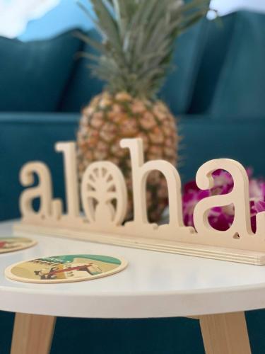 a wooden table with a pineapple on top of it at Chic Maui Condo Steps From Beach & Ocean in Wailea