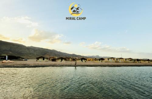 a view of a body of water with houses in the background at Miral Camp in Nuweiba