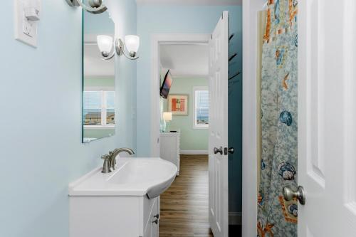 a bathroom with a sink and a mirror at Summer Breeze West in Emerald Isle