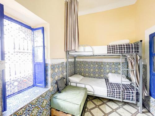 a room with two bunk beds and a window at Sun Hostel in Marrakesh