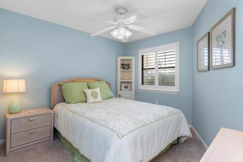une chambre avec un lit et un ventilateur de plafond dans l'établissement Summer Winds C-122, à Indian Beach