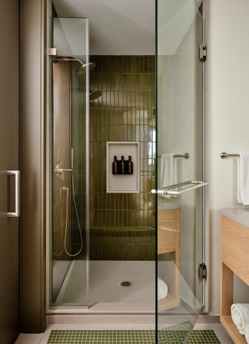 a shower with a glass door in a bathroom at The Atlas Hotel in Boston