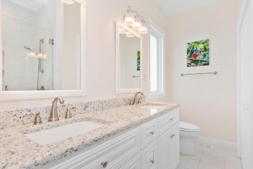 a white bathroom with a sink and a toilet at Ocean Club E-301 in Indian Beach