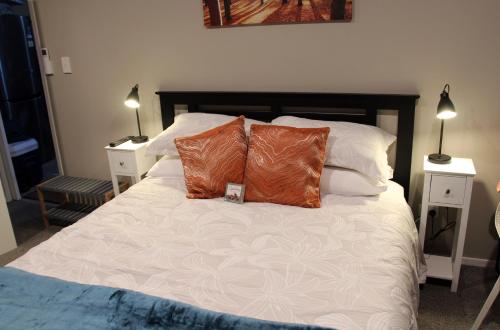 a bedroom with a bed with two pillows on it at The Studio Haven in Hamilton