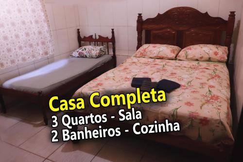 a bedroom with a bed with avertisement for at Casa Ybirá de Alter do Chão in Alter do Chao