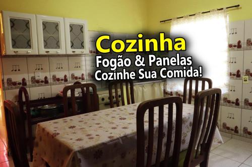 a room with a table and chairs in a kitchen at Casa Ybirá de Alter do Chão in Alter do Chao