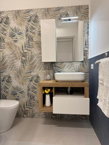 a bathroom with a sink and a mirror at Sasi Home in Terrasini