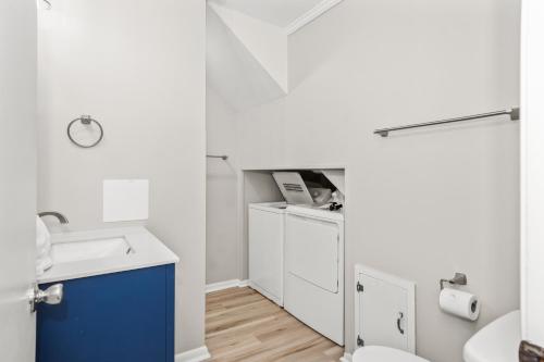 a white bathroom with a sink and a toilet at Carolina Clipper East in Emerald Isle