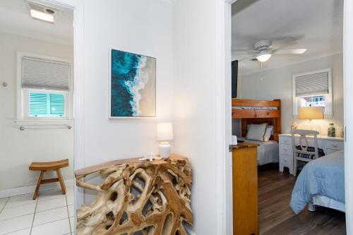 a room with a bedroom and a bed and a table at Salty Haven in Emerald Isle