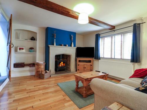 a living room with a couch and a fireplace at Ash House in Alton