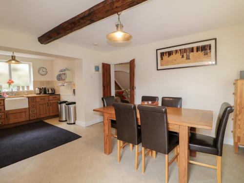 a kitchen and dining room with a wooden table and chairs at Ash House in Alton