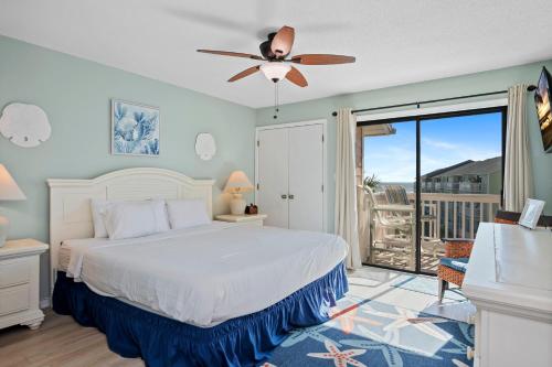 a bedroom with a bed and a ceiling fan at Pebble Beach D302 in Cedar Point