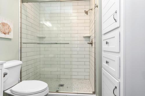 a bathroom with a shower with a toilet at Paradise West in Indian Beach
