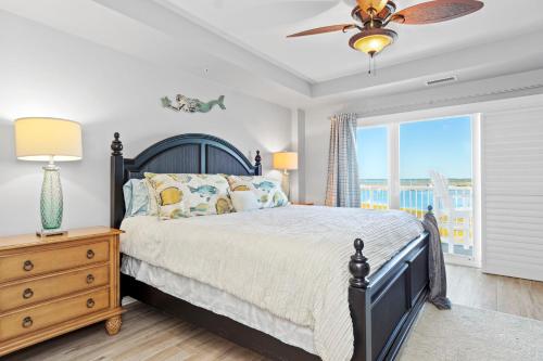 a bedroom with a bed and a dresser and a window at Olde Towne Yacht Club 713 in Beaufort