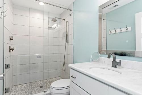 a bathroom with a toilet and a sink and a shower at All About Bubbles in Indian Beach