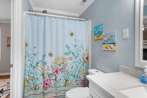 a bathroom with a shower with a shower curtain at Bikini Bottom in Cedar Point