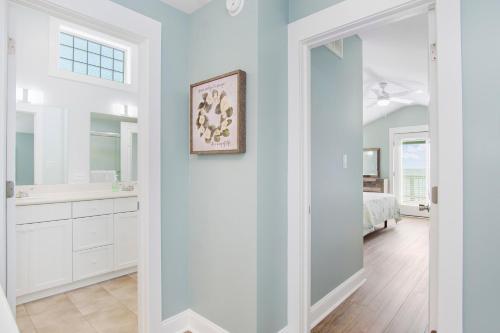 a white bathroom with a sink and a mirror at C-Life in Emerald Isle
