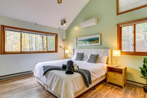 a bedroom with a bed and two windows at Luxury Home with Game Room, 4 Mi to Bushkill Falls! in Saw Creek