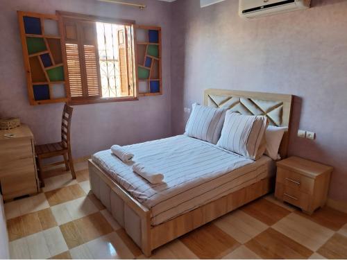 Una cama o camas en una habitación de Oasis Menara