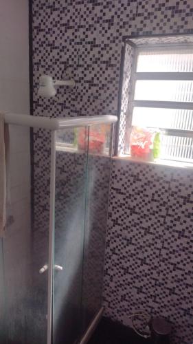 a bathroom with a shower with a glass door at VILA LEME Casa 11A in Rio de Janeiro