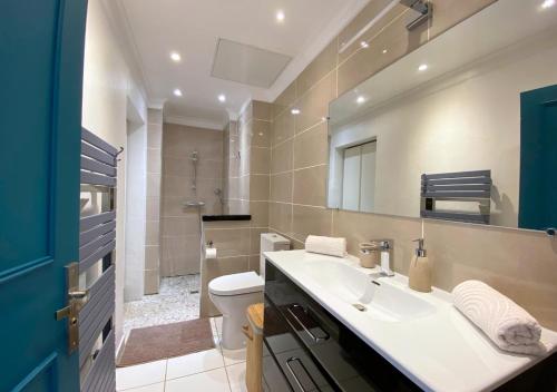 a bathroom with a sink and a toilet and a mirror at Le Gatsby 3 Etoiles - Tennis - Vue mer in Hyères