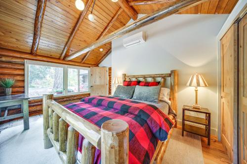 a bedroom with a bed in a room with wooden ceilings at Contemporary Log Cabin Near Cle Elum Lake! in Driftwood Acres