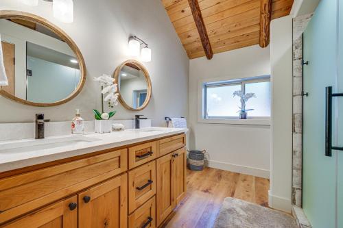 a bathroom with a sink and a mirror at Contemporary Log Cabin Near Cle Elum Lake! in Driftwood Acres